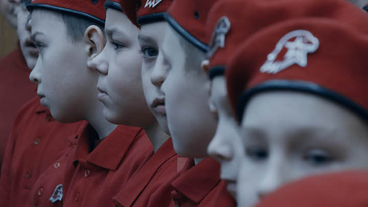 Young cadets with red berets look at each other